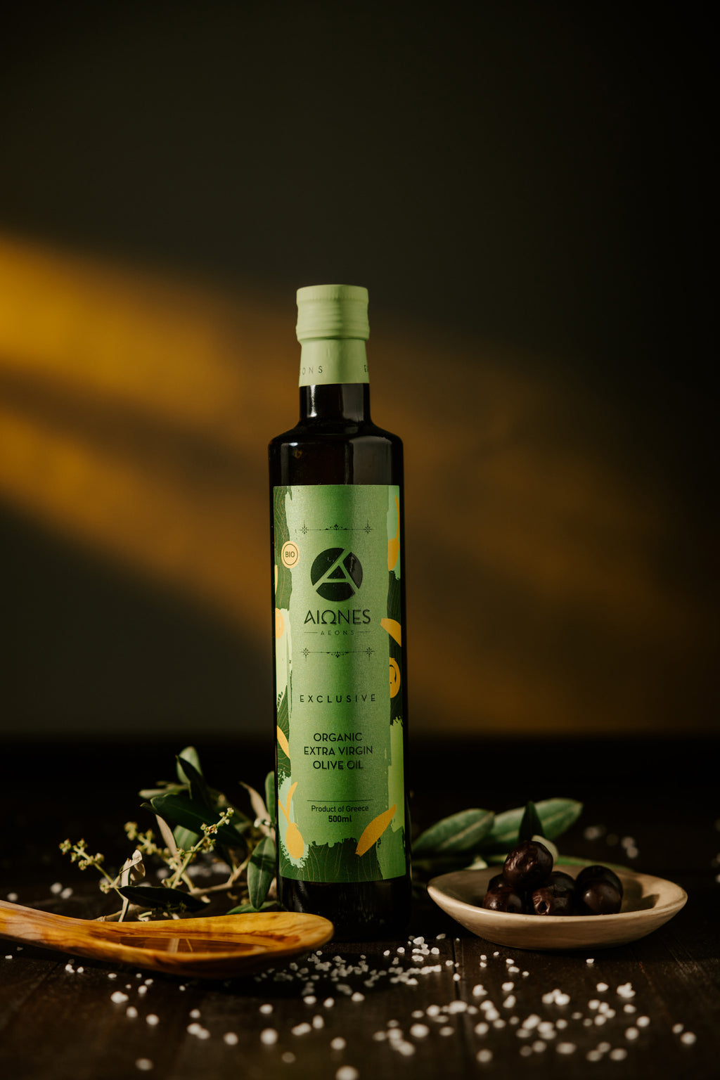 Bottle of AEONS olive oil with a dark background